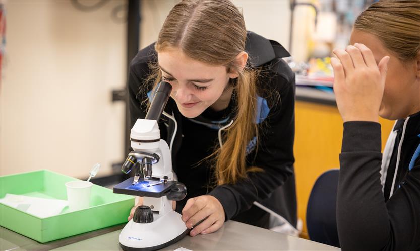 Students use microscopes in science class